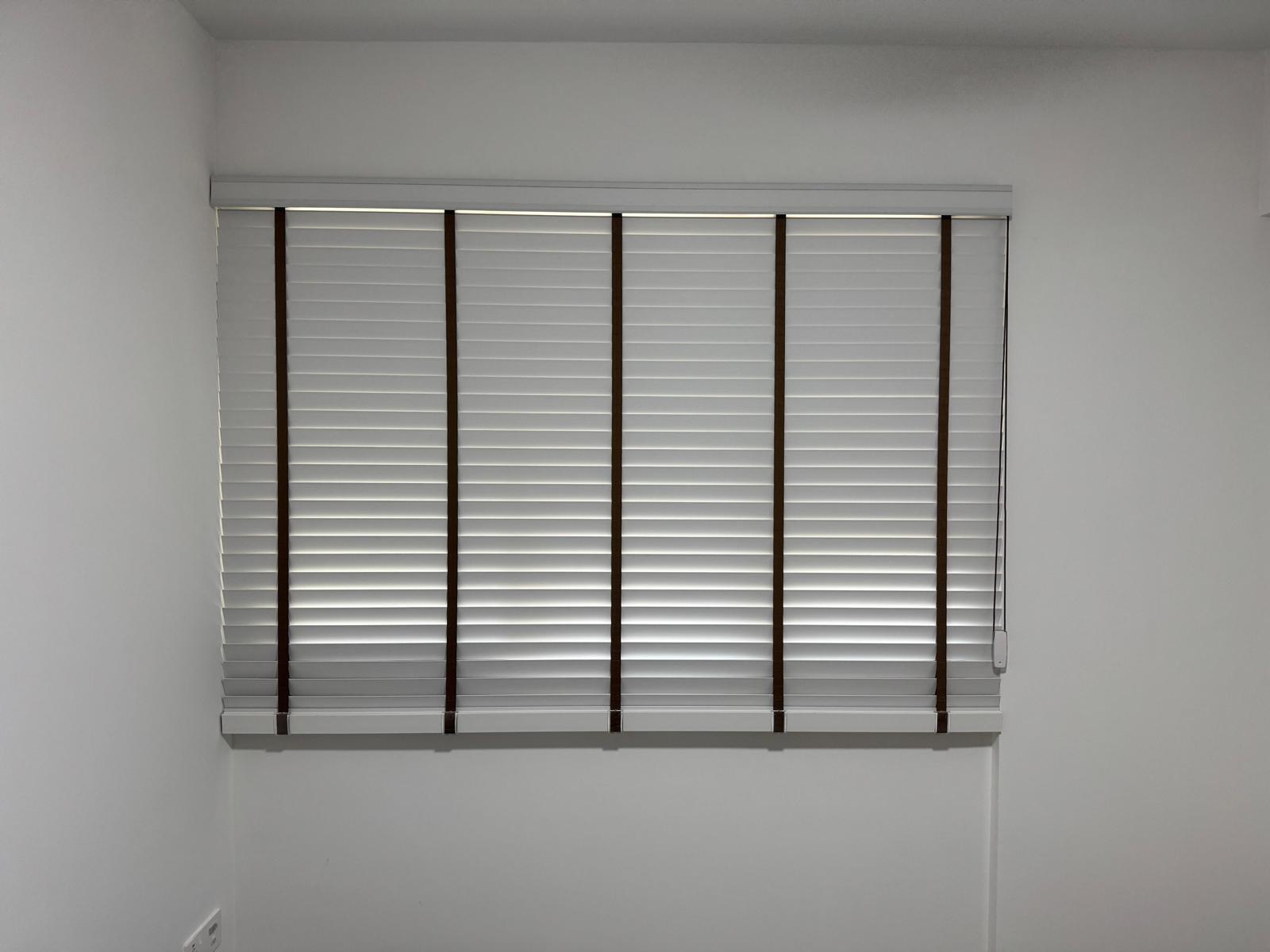 Light grey roller blind fitted within a recessed window