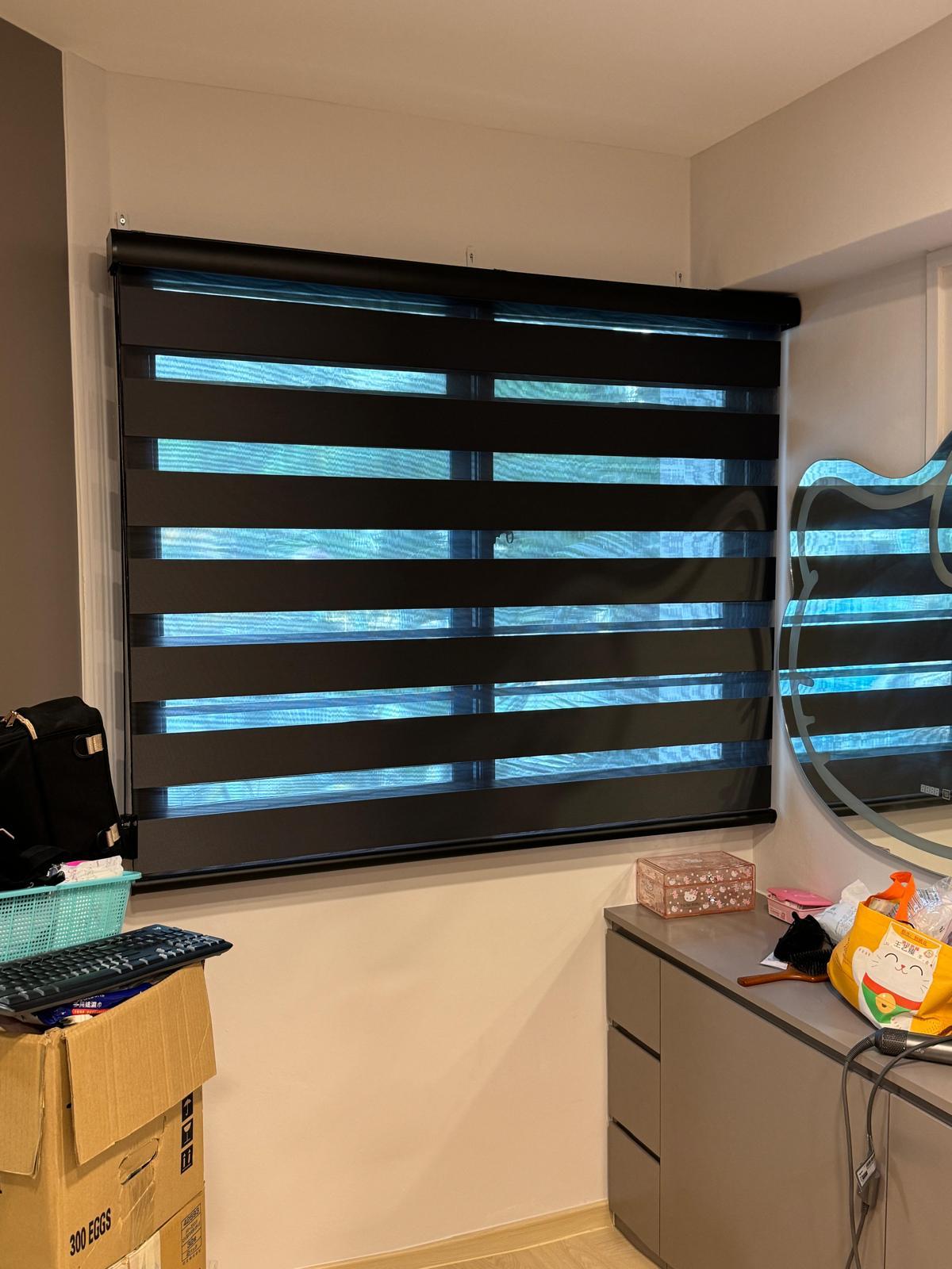 Dark blackout roller blind fitted neatly inside a window frame