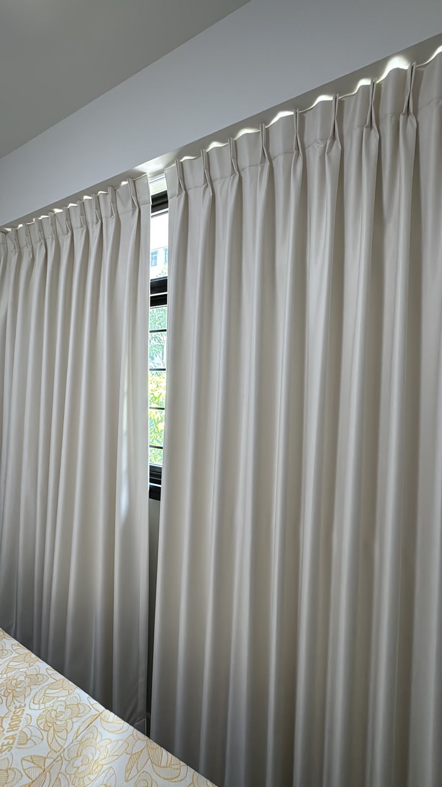 Full-length neutral curtains with a tailored pleat