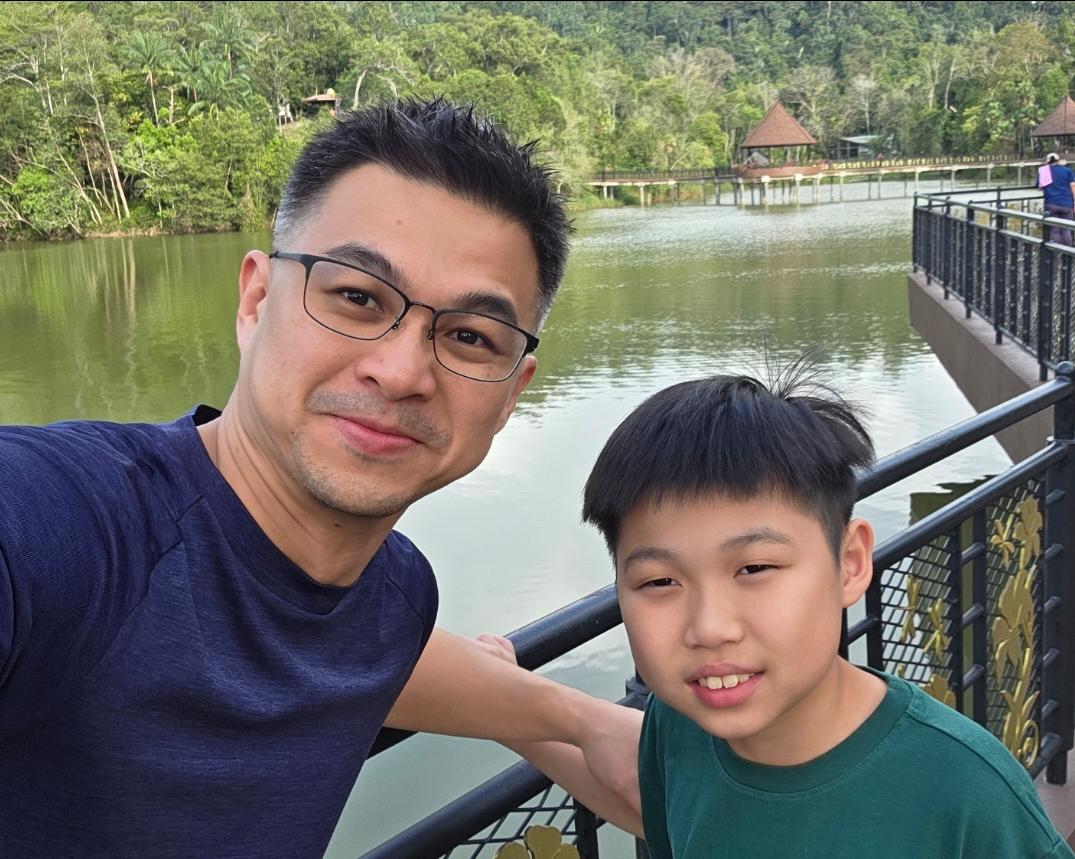 A father and child beside a lake